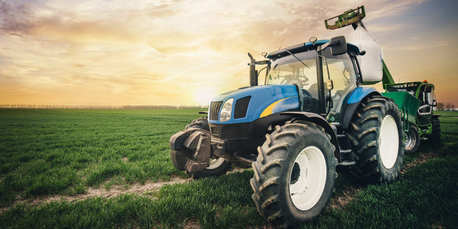 a-tractor-with-a-sack-of-fertilizer-moves-along-the-field-in-the-spring