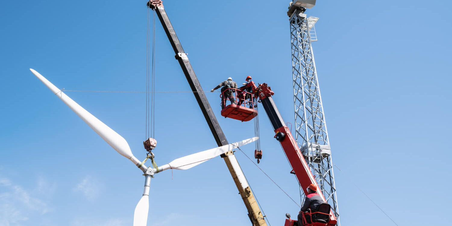installers-use-truck-crane-and-aerial-platform-to-raise-wind-turbine-rotor