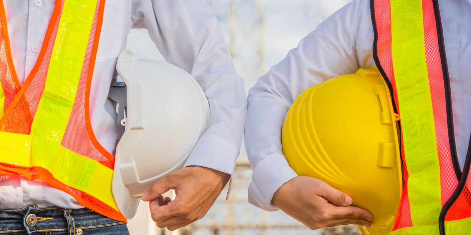 man-and-women-engineer-holding-hardhat-safety-standing-outdoor-teamwork-management-project