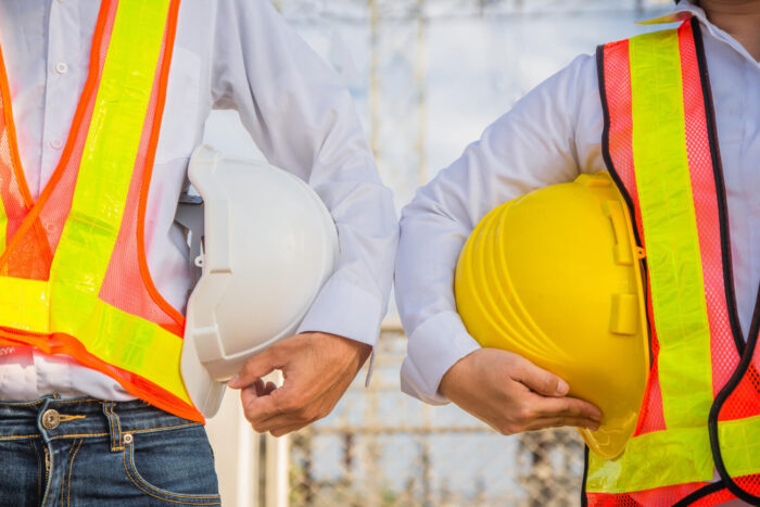 man-and-women-engineer-holding-hardhat-safety-standing-outdoor-teamwork-management-project