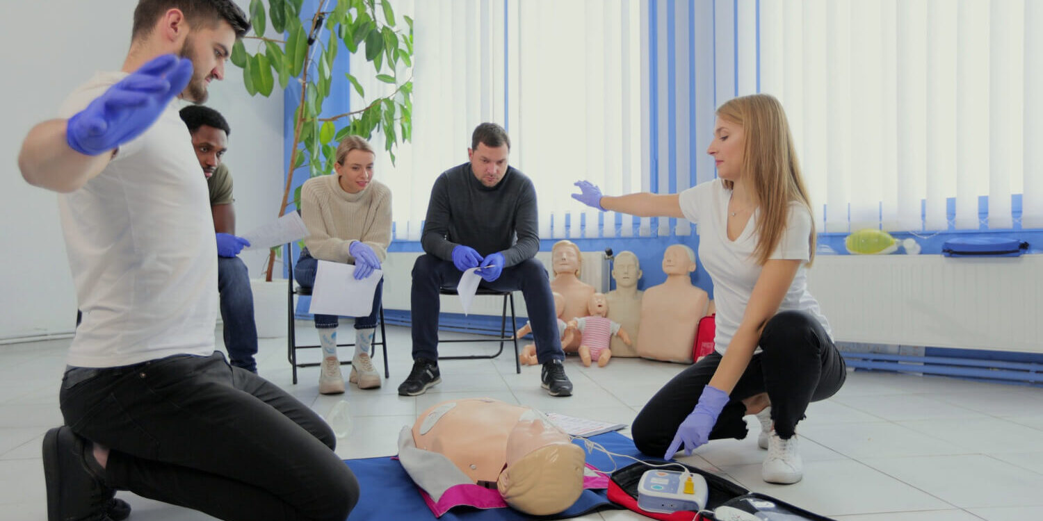 stay-away-moment-during-the-defibrillation-process-on-a-first-aid-group-training-indoors