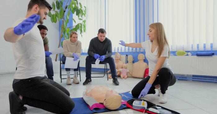 stay-away-moment-during-the-defibrillation-process-on-a-first-aid-group-training-indoors