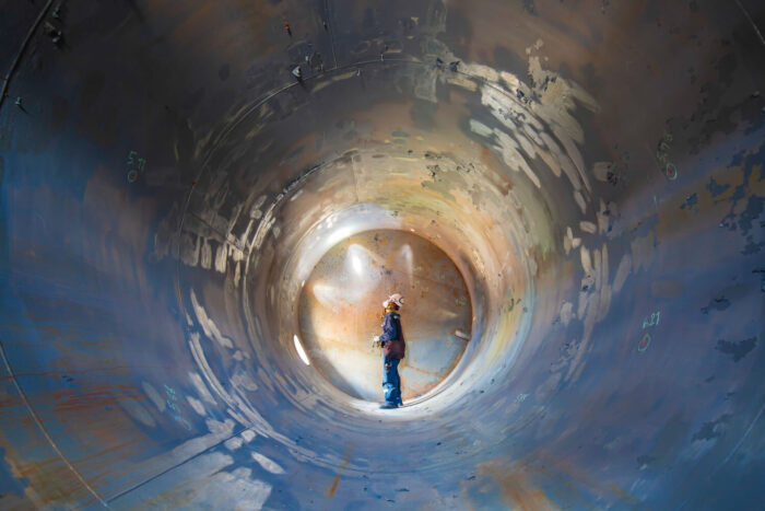 working-male-inspection-weld-underground-of-tank-equipment-tunnel-by-using-the-flashlight-in-side-confined